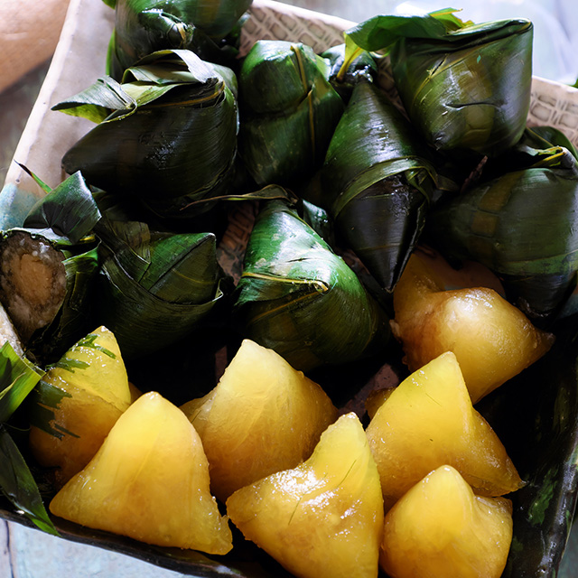 Vietnamese traditional food for may 5th, is double five festival or tet doan ngo, sticky rice cake in green leaf, also call banh u tro with pyramidal shape